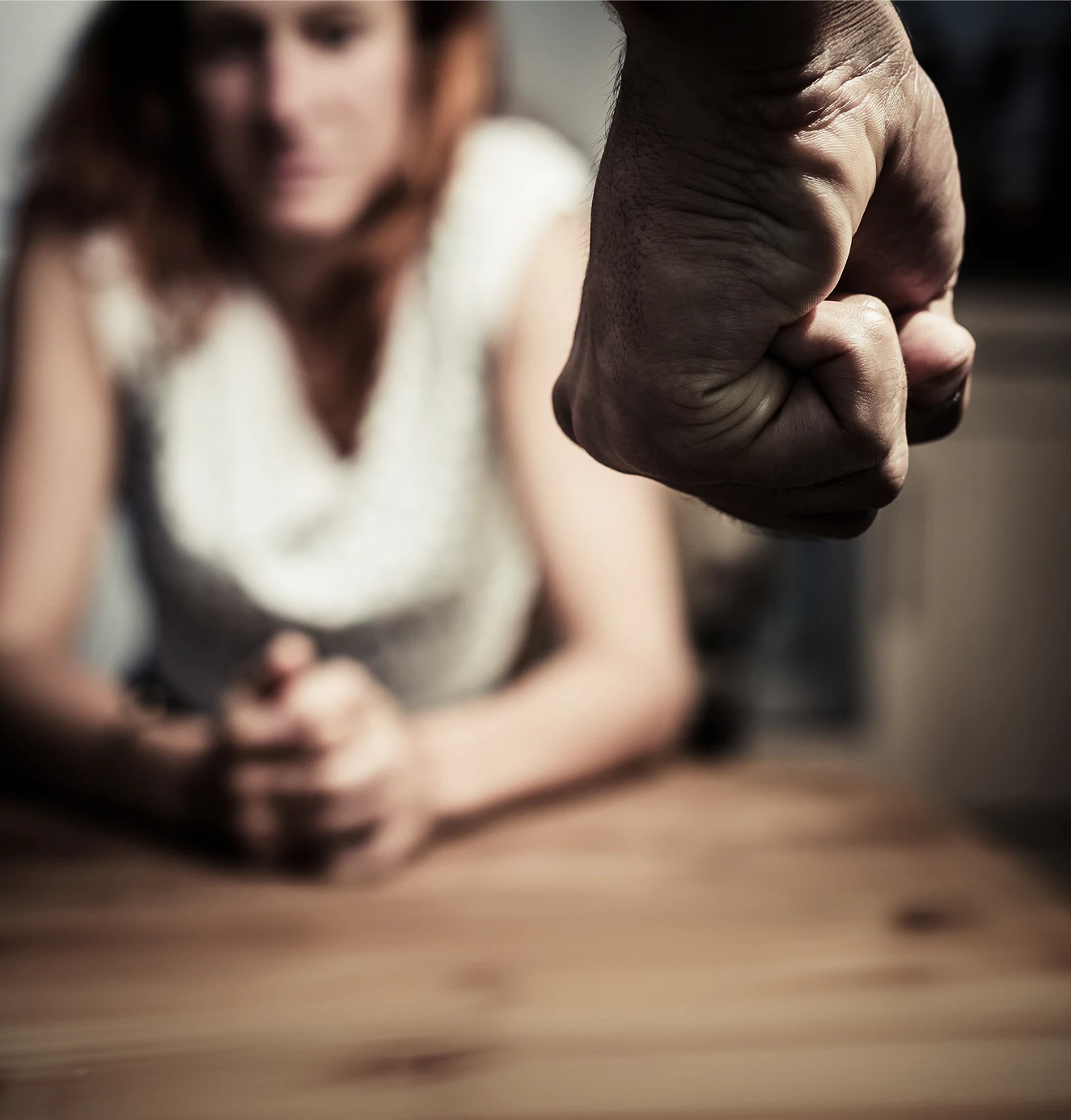 Man w/ a balled up fist looking at woman