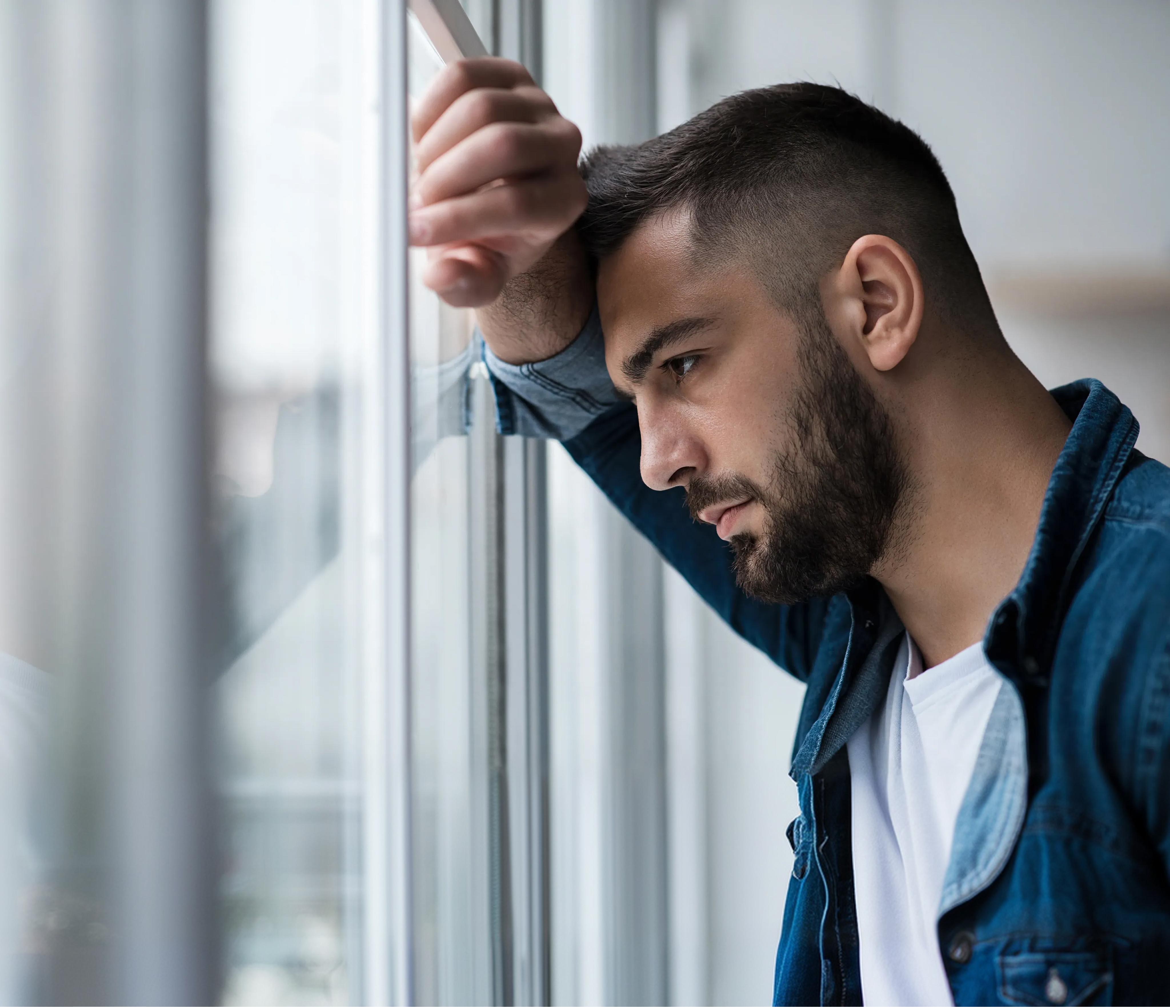 man looking out the window