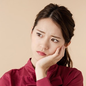 woman holding jaw in pain