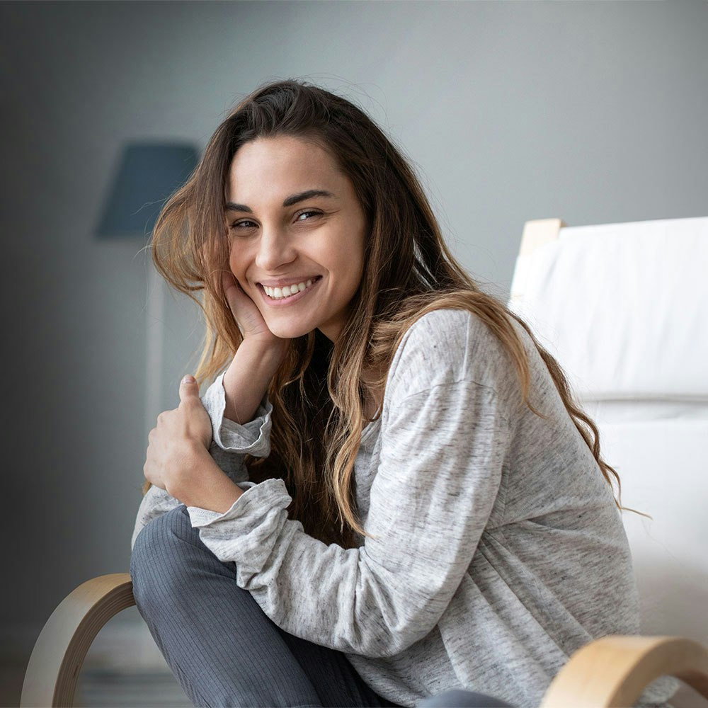 Woman smiling on her couch