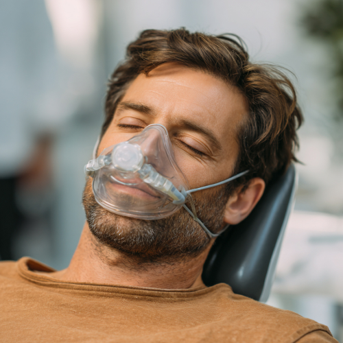 man inhaling nitrous oxide