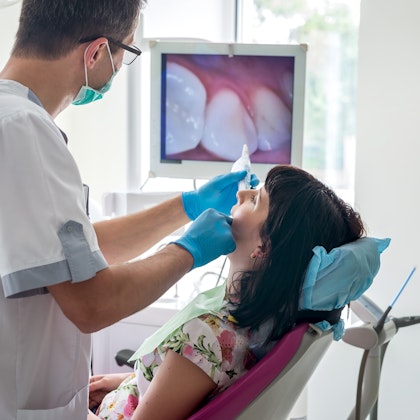 dentist examining patient's mouth