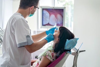 dentist examining patient's mouth