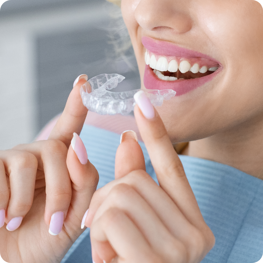 woman placing Invisalign aligner