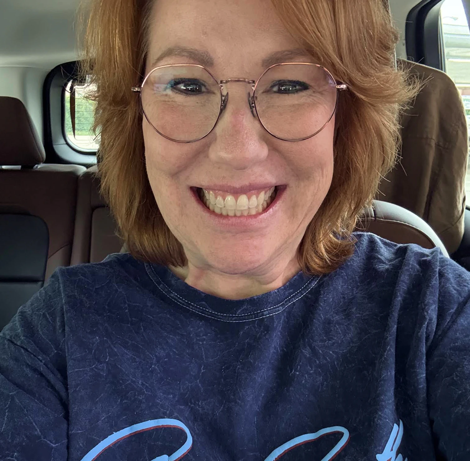 Woman smiling in her car