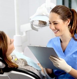 Dental patient discussing payment with staff