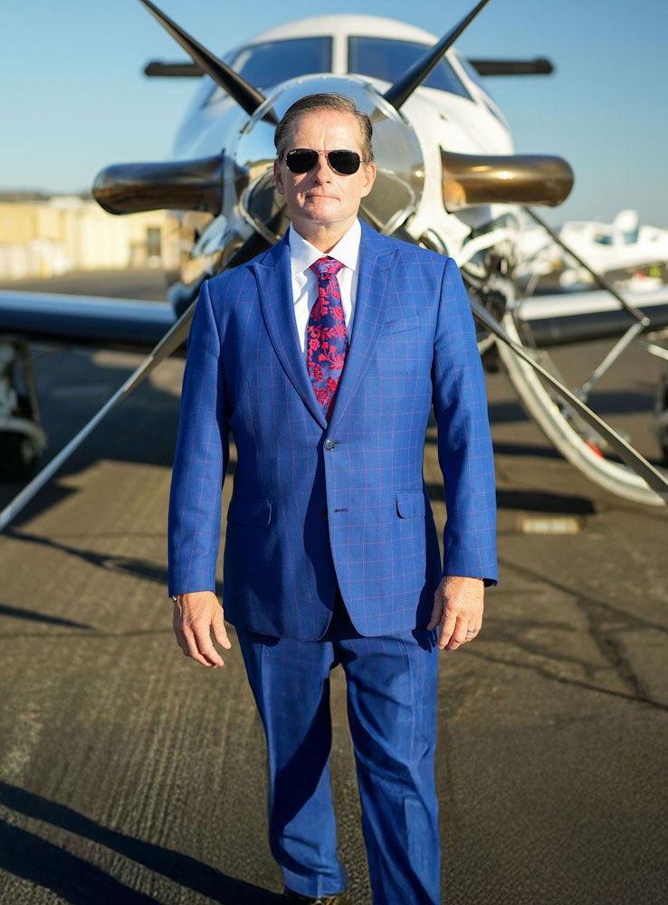 Attorney Christopher Dolan in front of a private plane