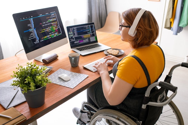 Woman in wheelchair working at desk