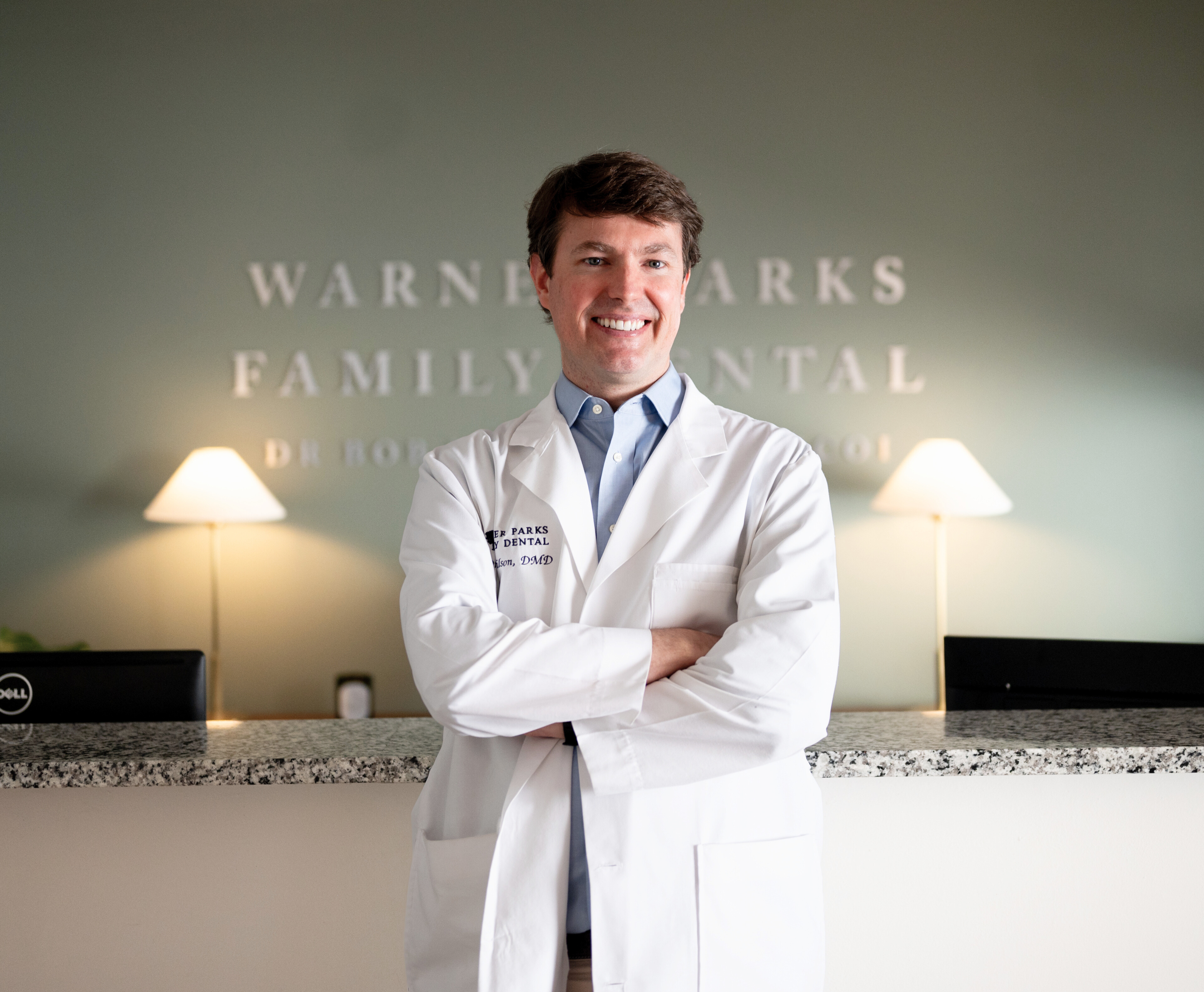 Dr. Bob Wilson smiling at front desk