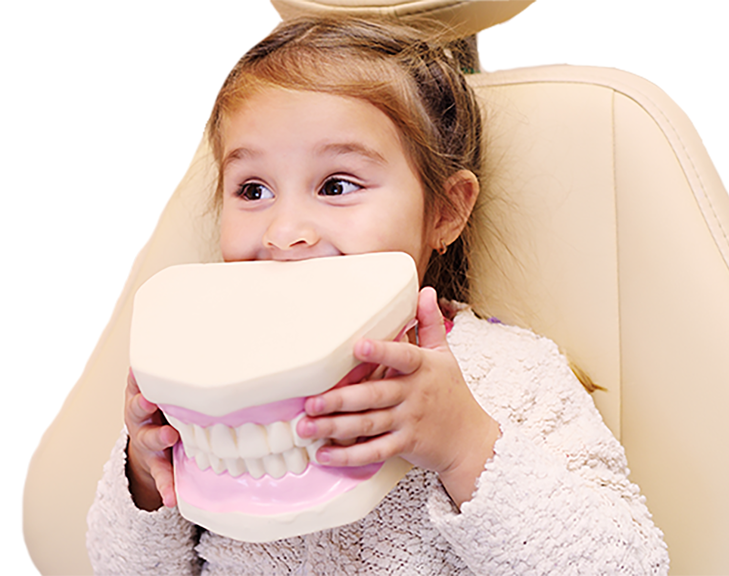 Young girl holding up tooth model to her mouth
