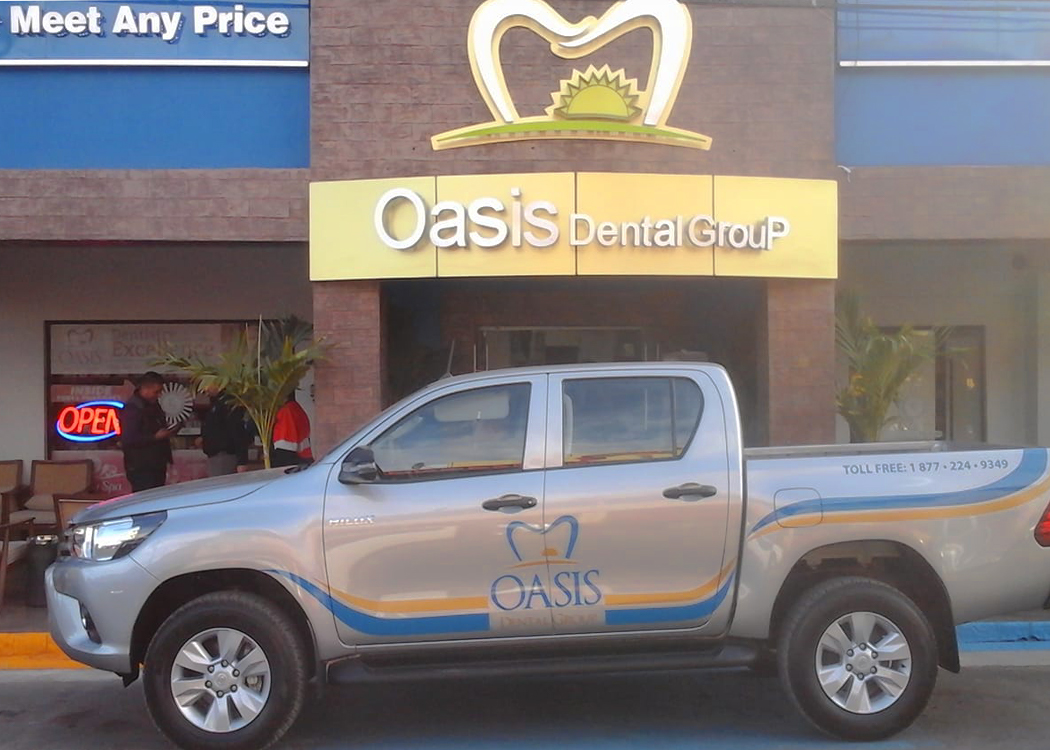 Exterior of Oasis Dental Group and the Oasis Dental truck