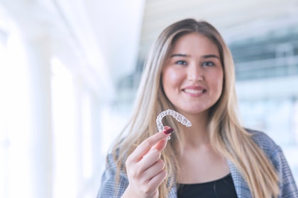 Young woman holding Invisalign