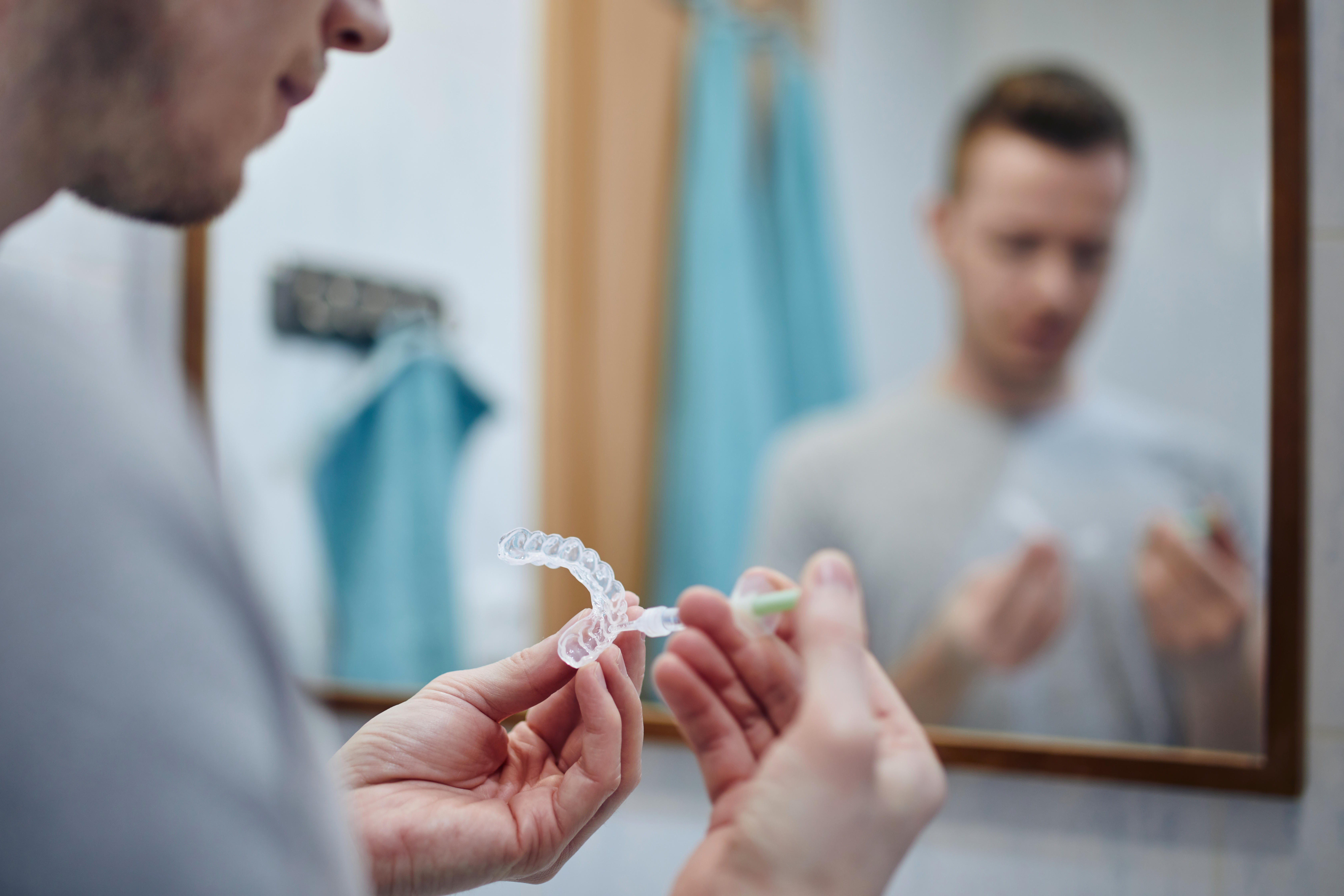 Man filling an at-home teeth whitening tray
