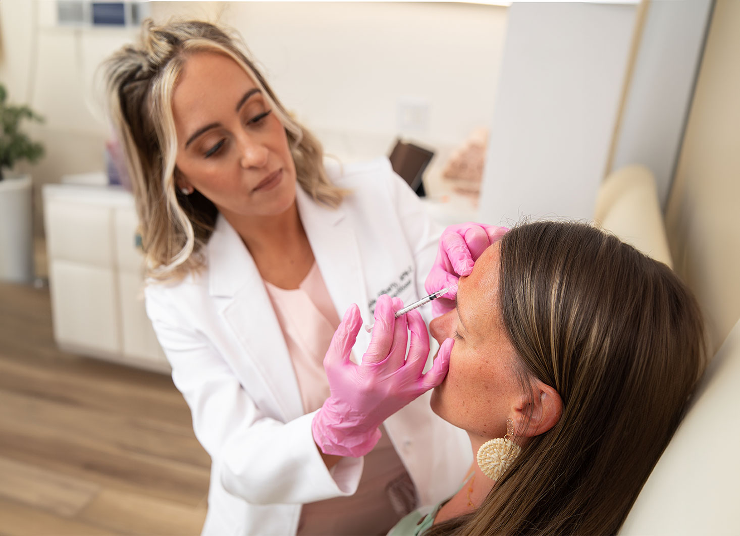 Nichole Gilbarty administering injectable treatment