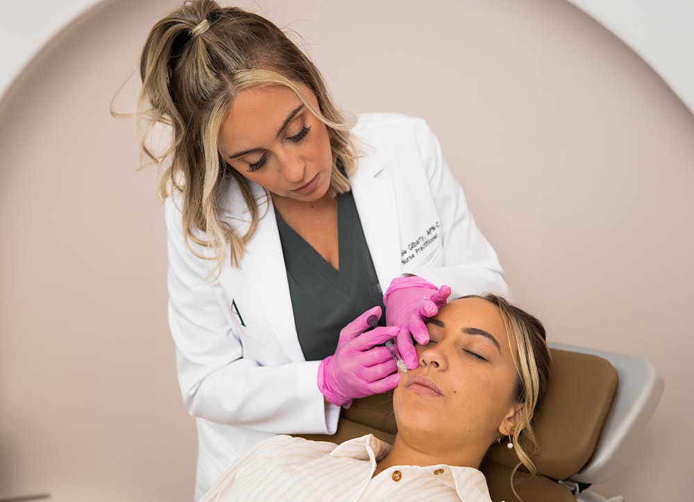 Nichole Gilbarty administering injectable treatment