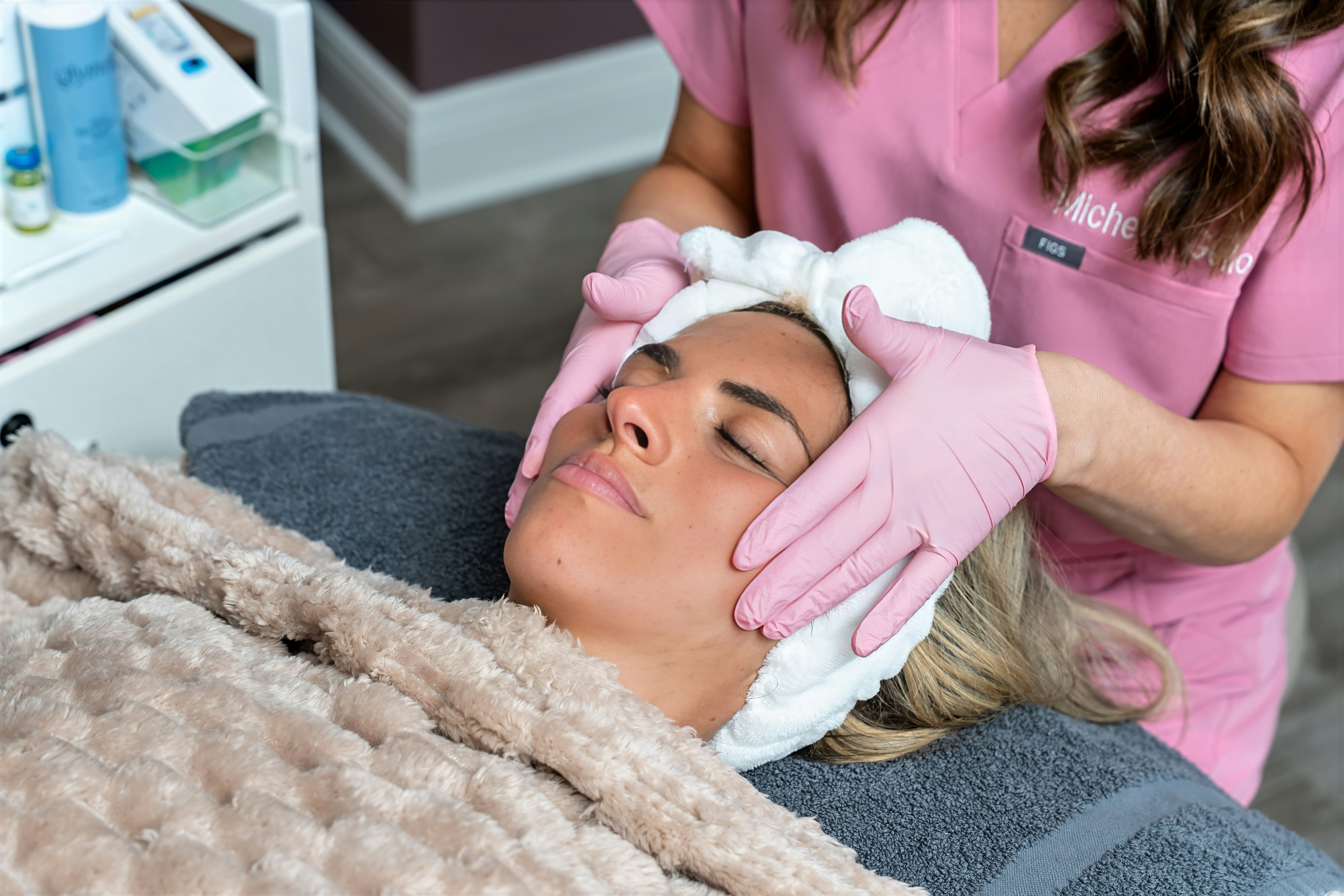 Woman getting chemical peel with purple towel