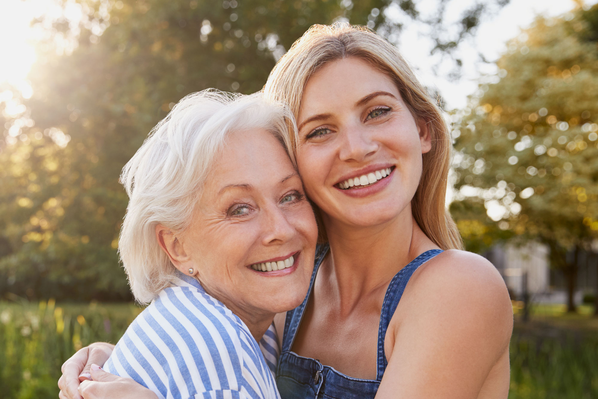 Happy woman and adult daughter after oral surgery