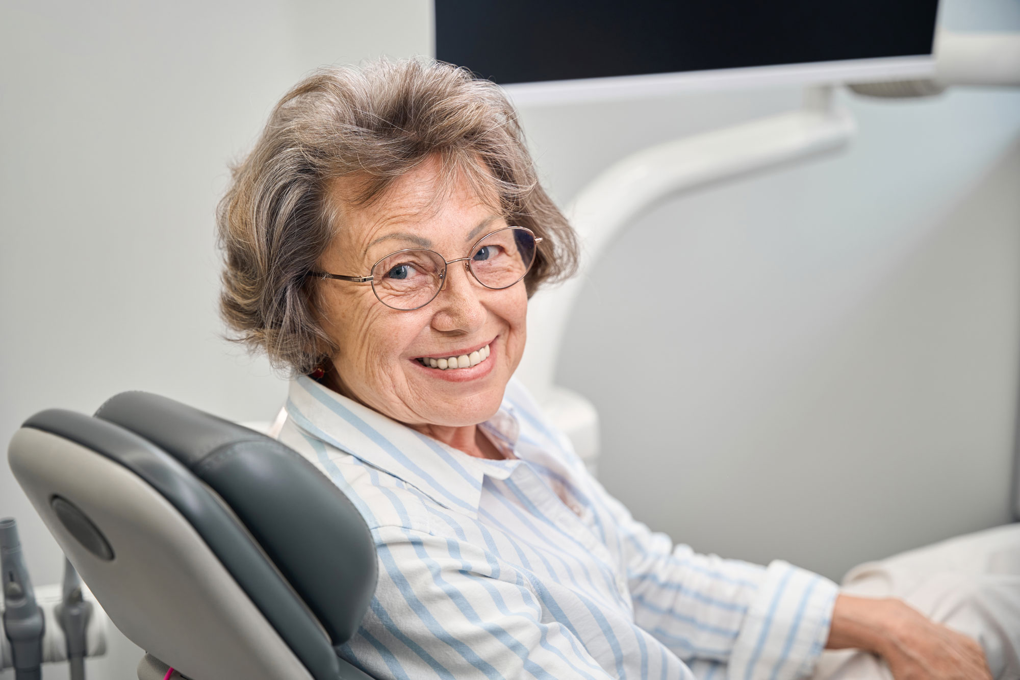 Smiling dental implant patient at a checkup