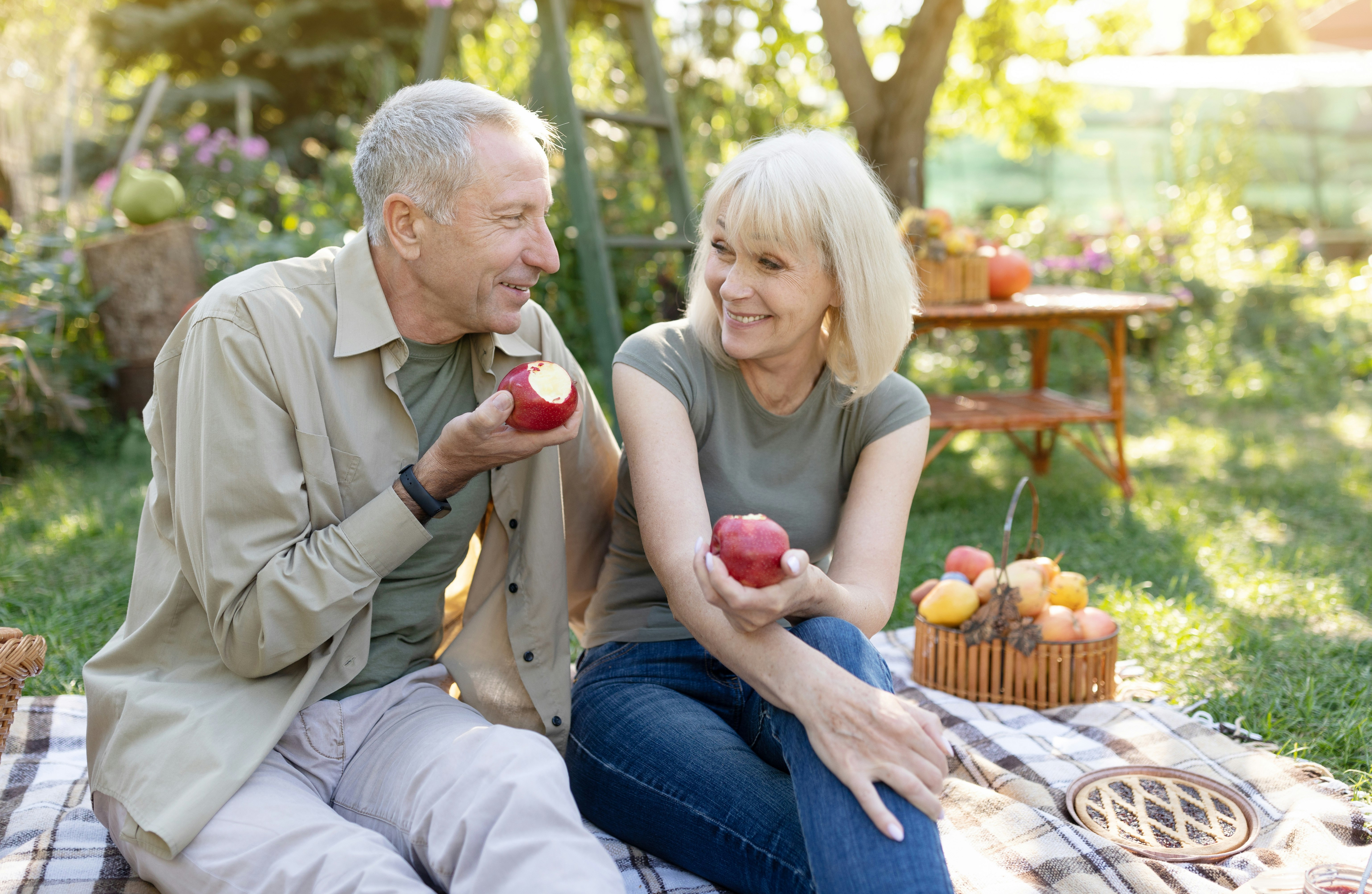 Older couple enjoying apples at an orchard