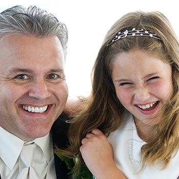 Man and little girl smiling