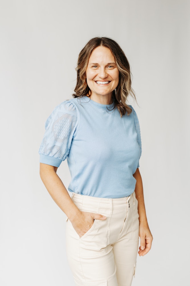 smiling woman in blue top