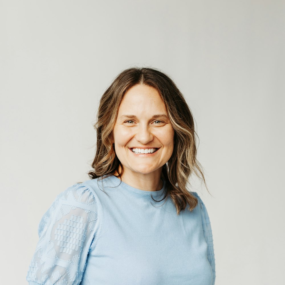 smiling woman in blue top