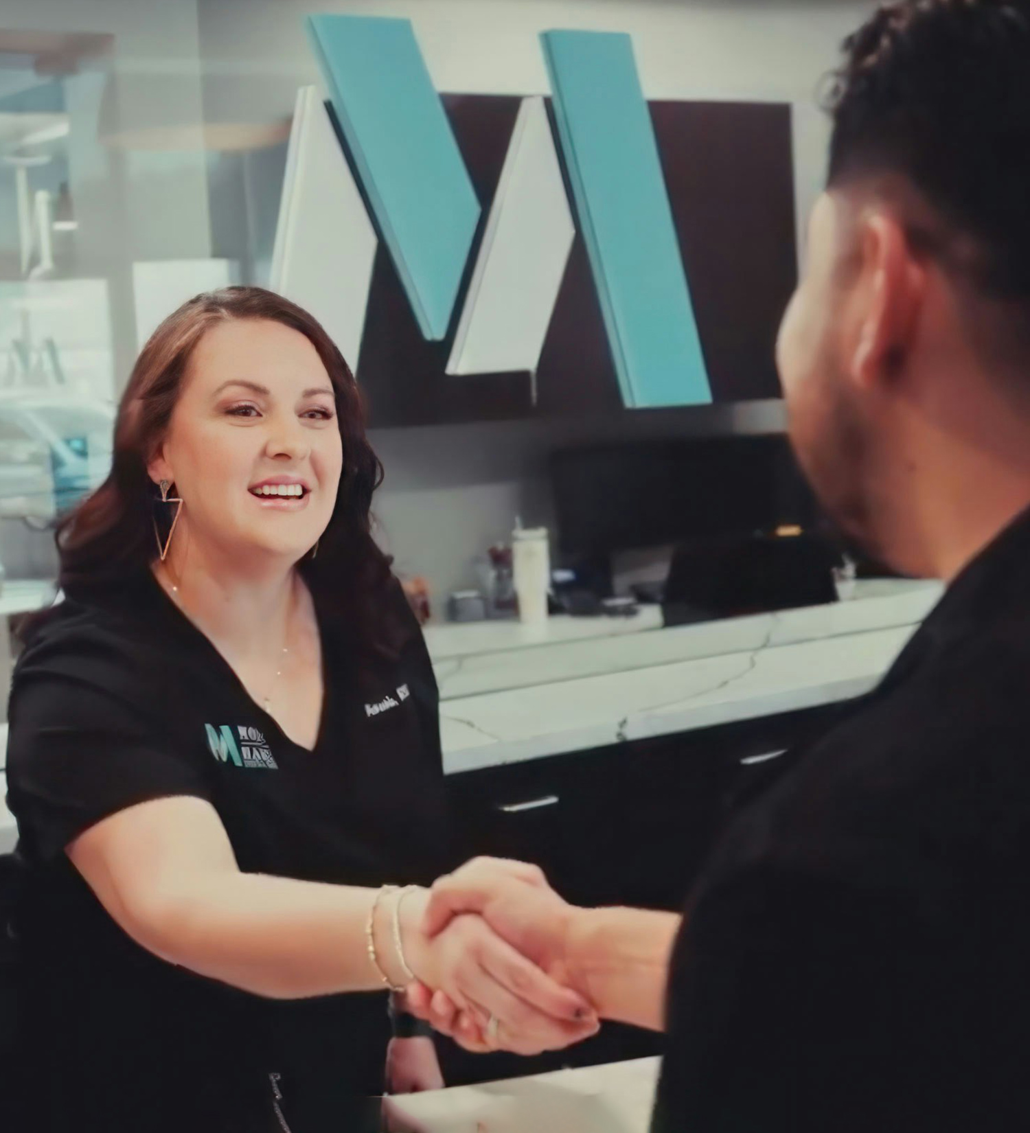 dental staff checking in patient at front desk