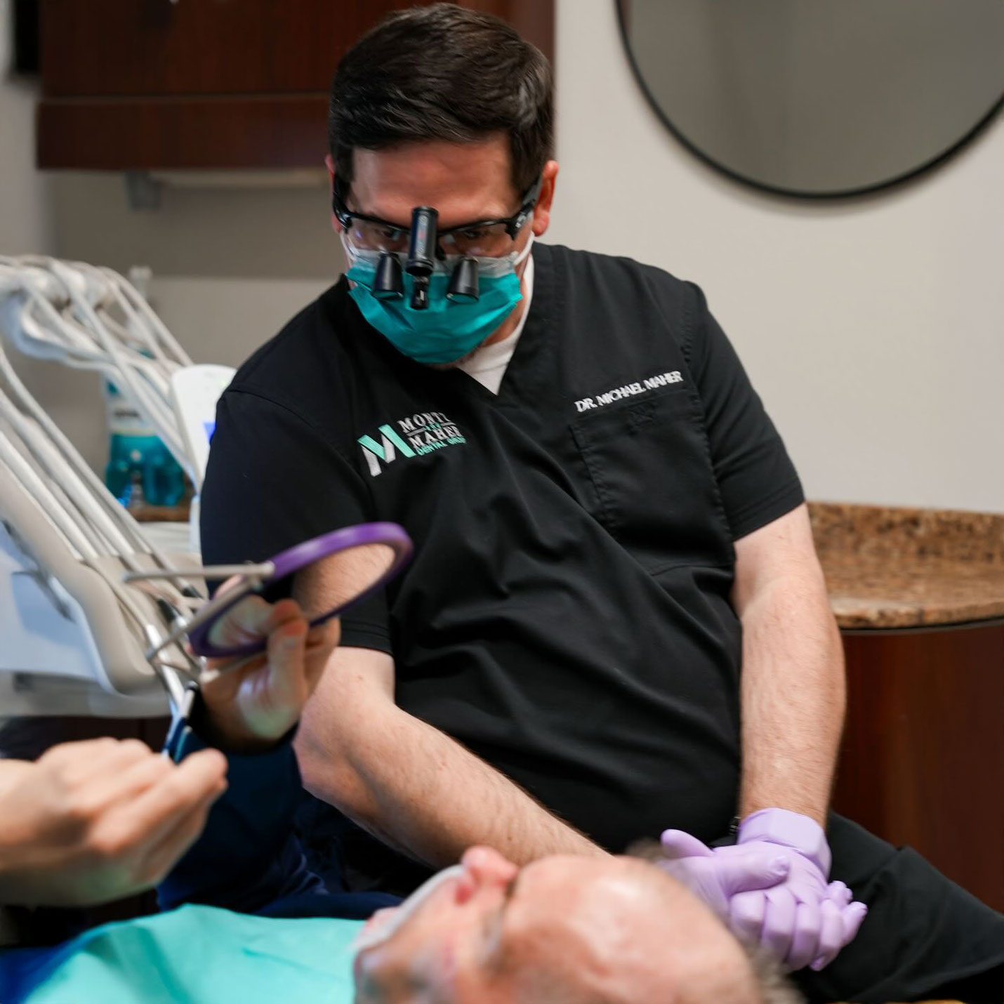 Montz and Maher Dental Group dentist speaking with a patient