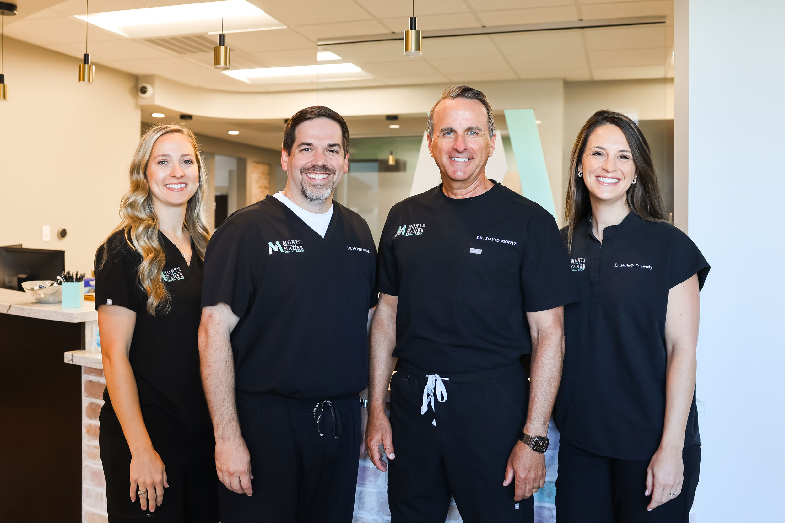 Dentists at Montz and Maher (Drs. Macie Long, David Montz, Michael Maher, and Nathalie Dunwody)