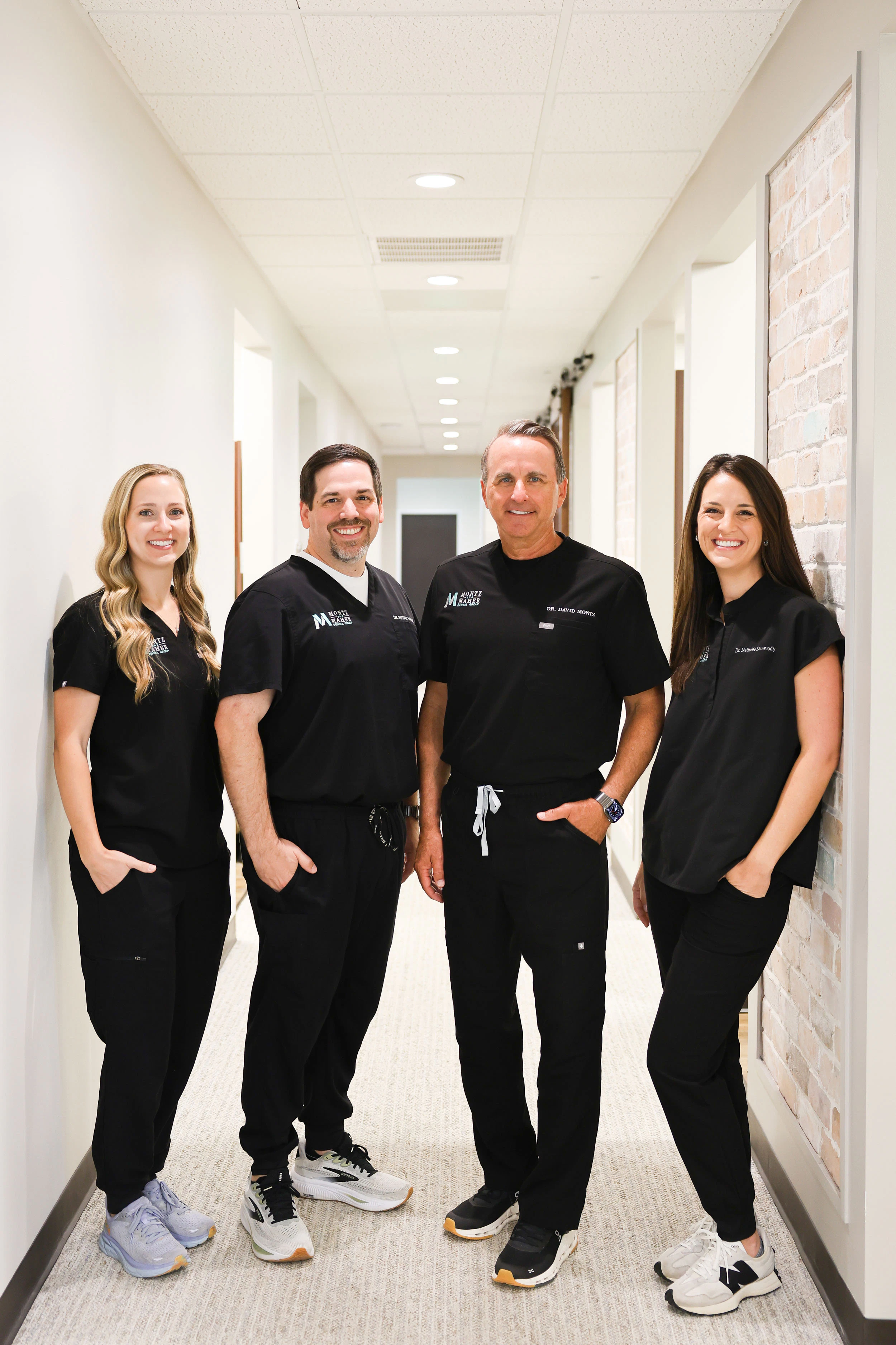 Dentists at Montz and Maher (Drs. Macie Long, David Montz, Michael Maher, and Nathalie Dunwody)
