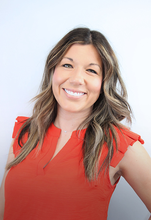 Smiling woman after dental crown treatment
