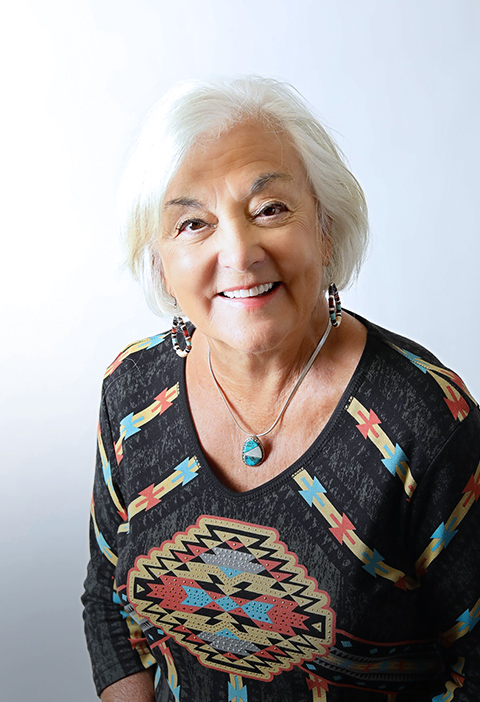 Smiling woman after dental bridge treatment