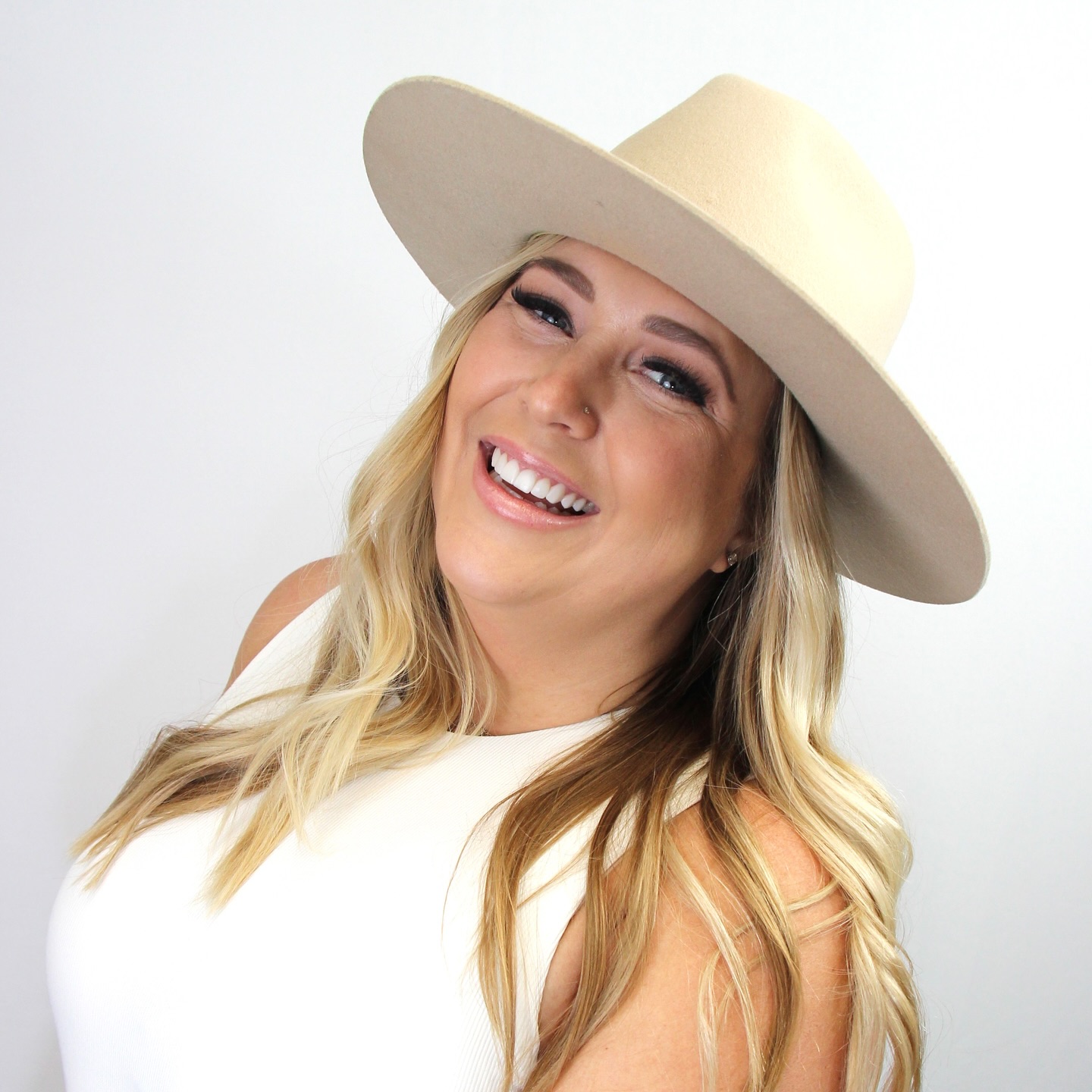 Dark haired woman with tattoos smiling