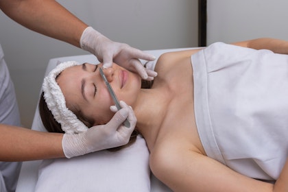 Woman getting a dermaplane facial