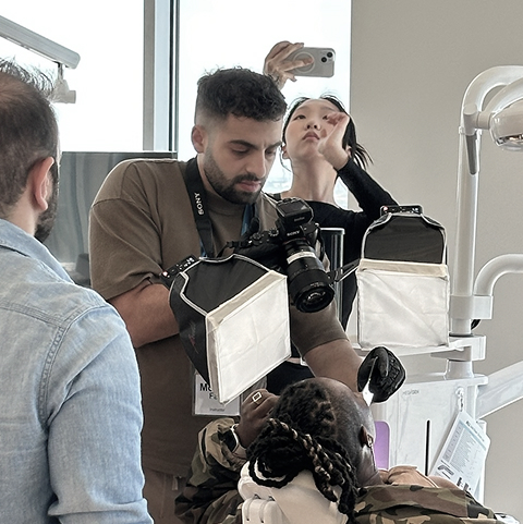 Dr. Mohaad A Faraj taking pictures of a patient's smile