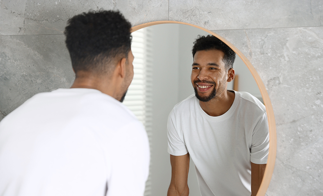 Bearded man smiling in the mirror