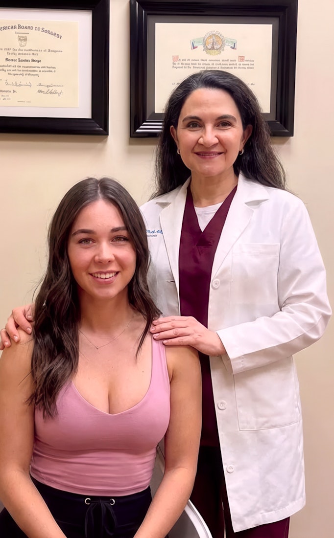 dr. daiza stands with patient wearing pink top
