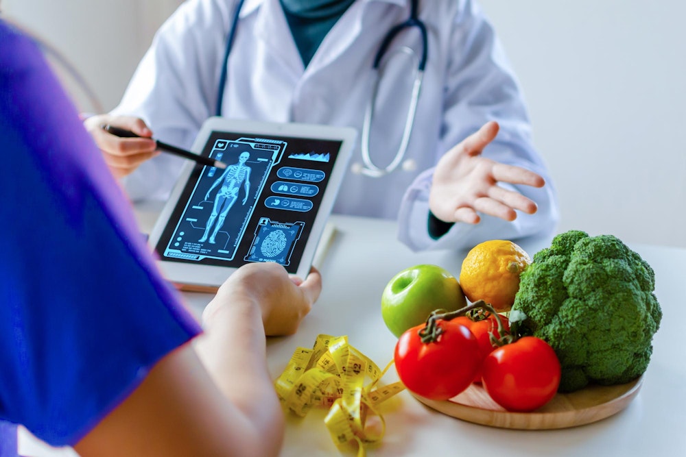 doctor explaining weight loss plan next to fruits and vegetables