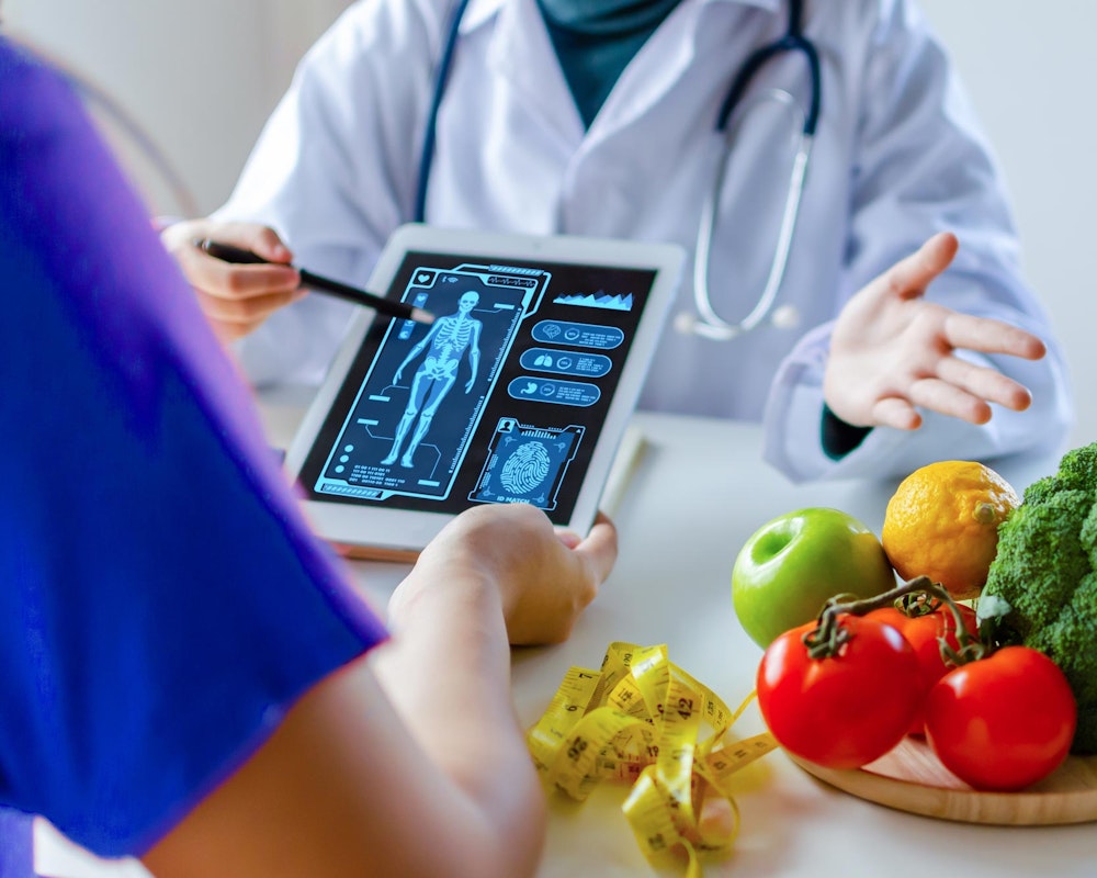 doctor explaining weight loss plan next to fruits and vegetables