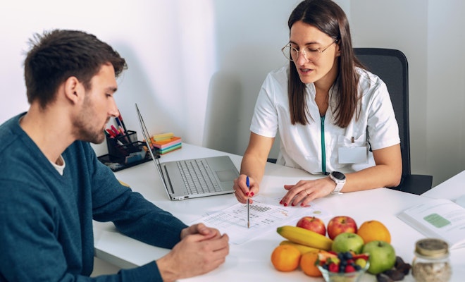 medical professional detailing a weight loss plan with a patient