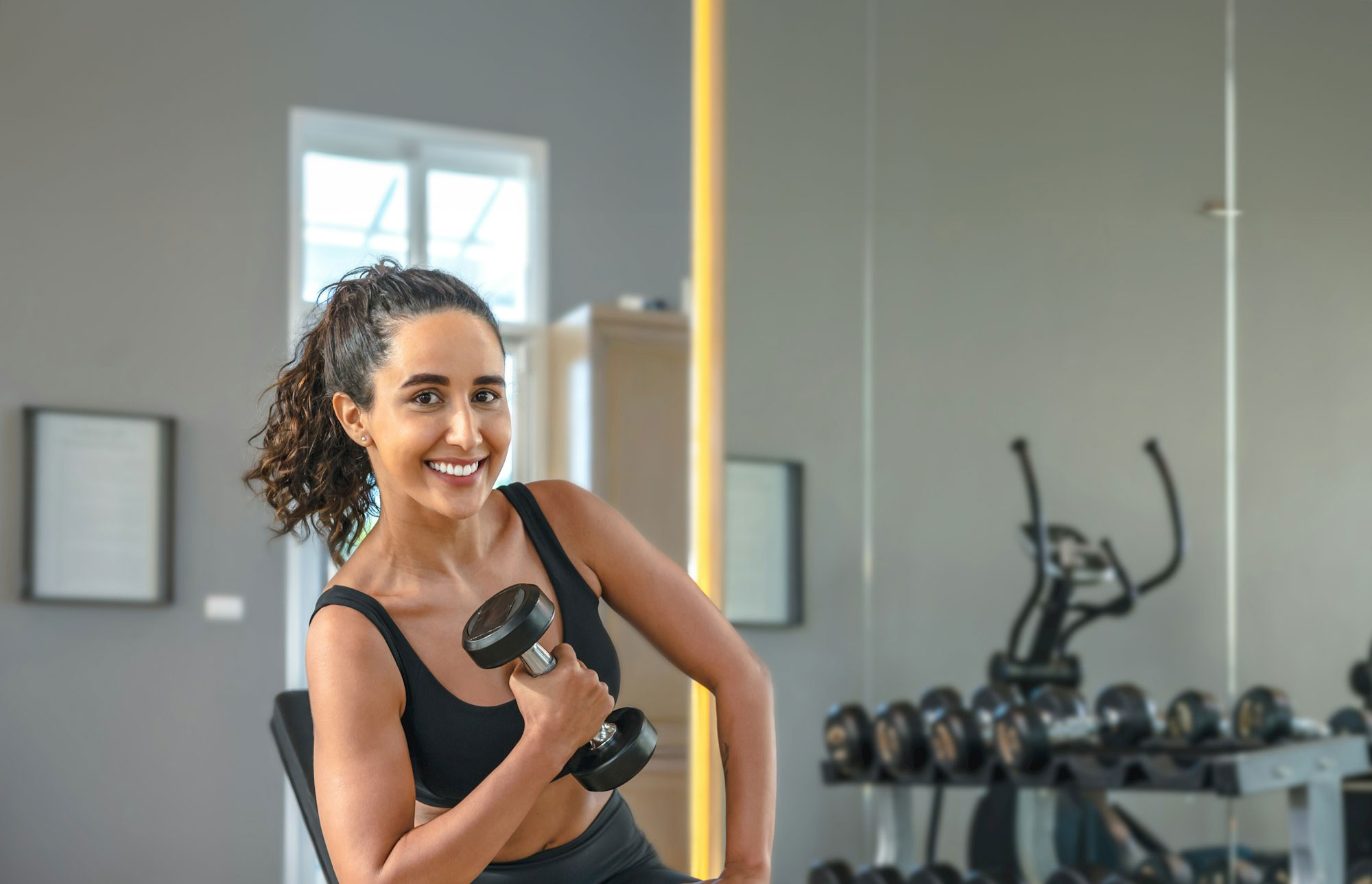 Happy woman lifting weights