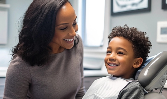 Smiling mom and young daughter at the dentist