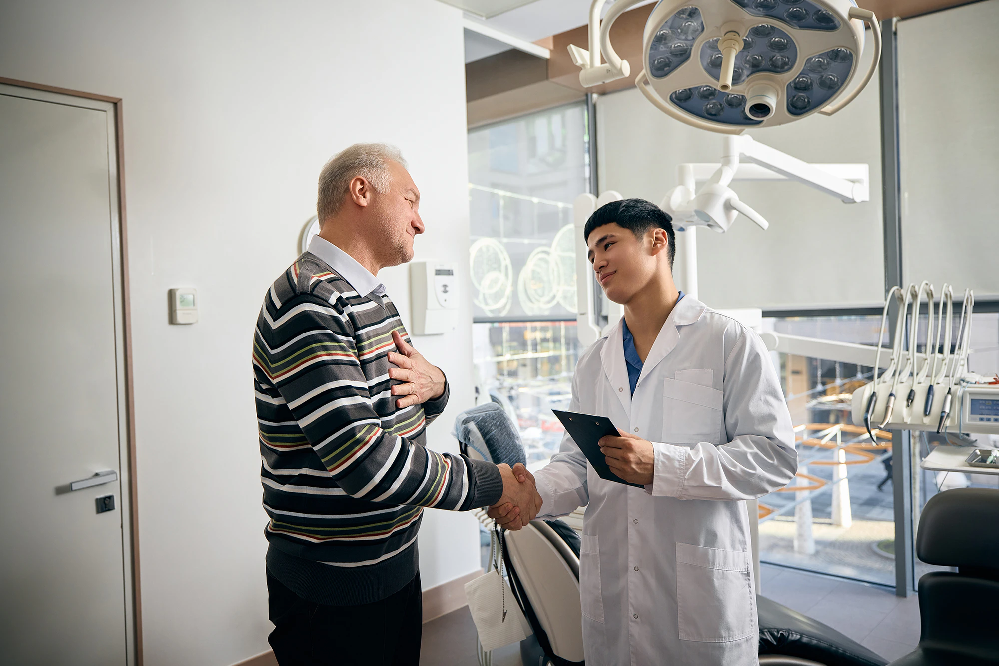 man shaking hands with his dentist