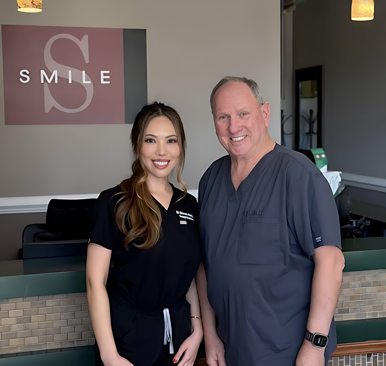 Dr. Victor Siegel standing with three dental team members in black scrubs
