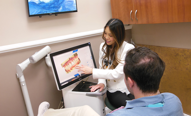 dentist showing patient a dental scan