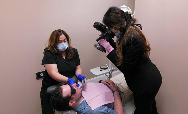 dentist taking a photo of a patient's smile