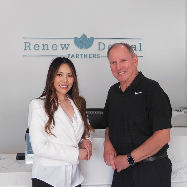 Dr. Victor Siegel standing with three dental team members in black scrubs