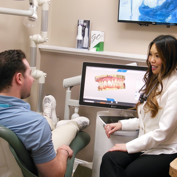 Dentist speaking with patient