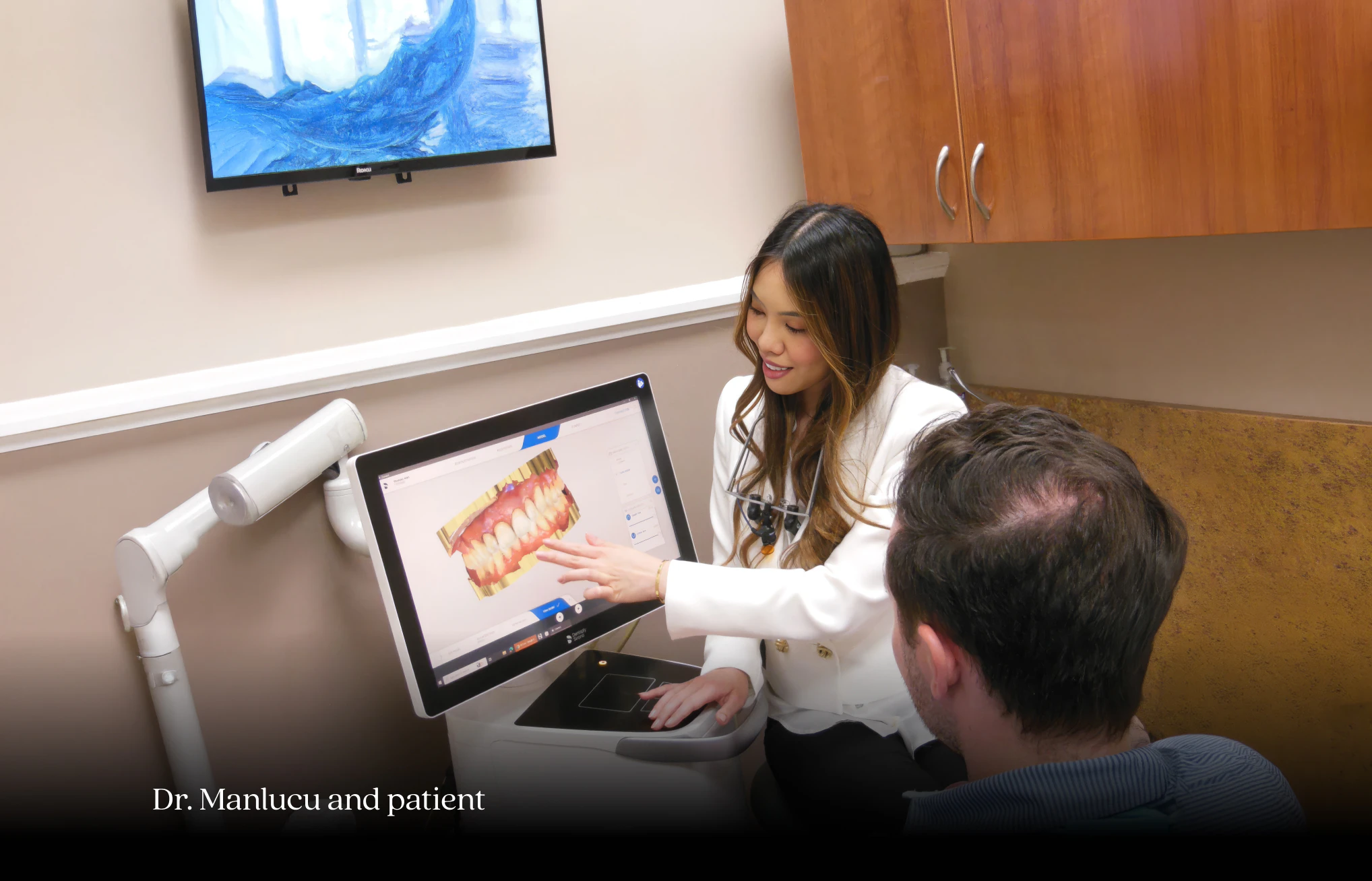 Dr. Manlucu showing patient digital scanner