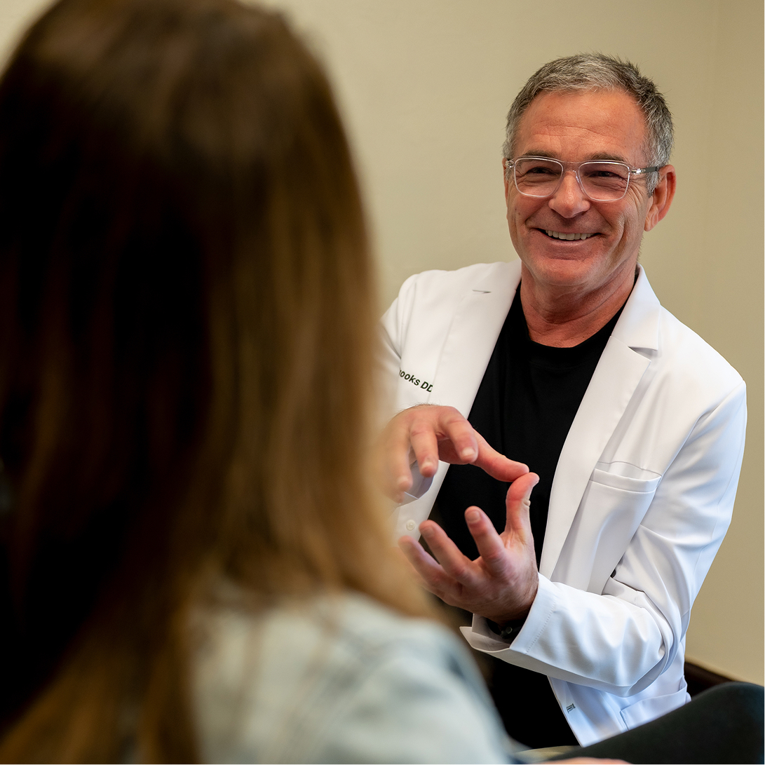 Dr. Tim J. Brooks with a patient 